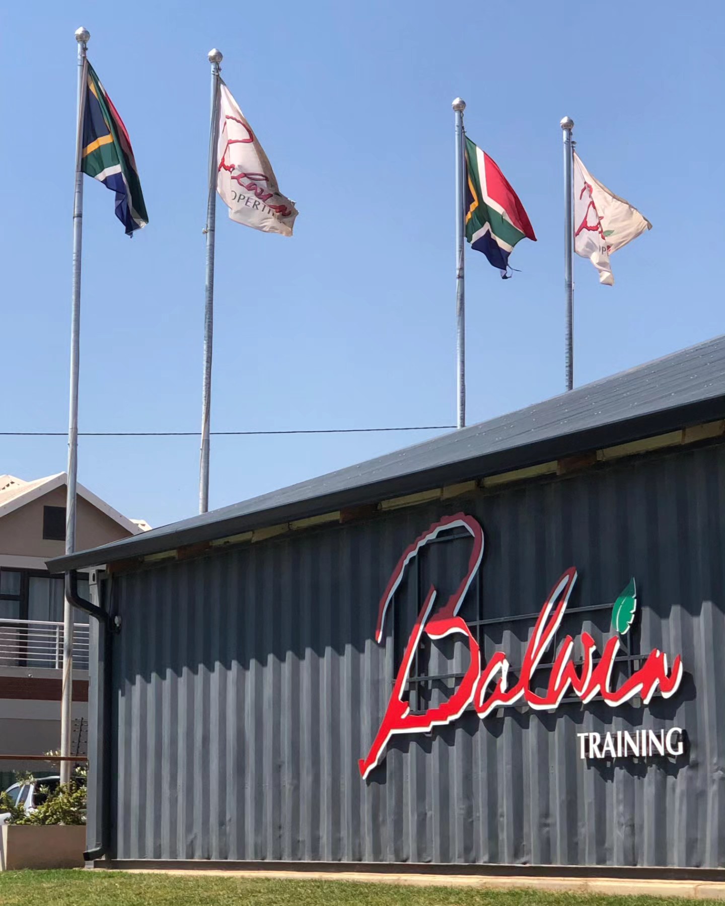 Flags flying outside the Balwin Training Centre